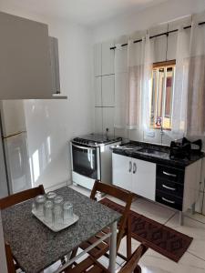 a kitchen with a table with glasses on it at Cozy house near Vila Aurora Station in Sao Paulo