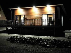 a house with lights on the side of it at night at Rivers Edge Apartment in Lake Tekapo