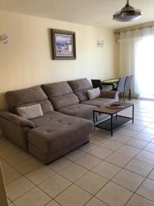 a living room with a brown couch and a table at Apartment Paraiso Royal in Playa de las Americas