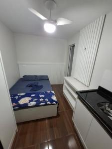 a small room with a bed and a kitchen at Pousada Solar Curitiba in Curitiba