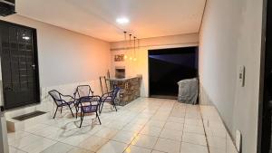 a kitchen with chairs and a table in a room at Studio do Bosque em Ponta Porã in Ponta Porã