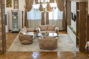 a living room with two chairs and a table at ECO ART Hotel in Tashkent