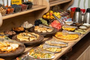 a buffet line with many different types of food at ECO ART Hotel in Tashkent