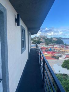 a balcony of a building with a view of a city at Beautiful view of Town in Saint Georgeʼs