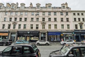 a street with cars parked in front of a building at Sunnie stays apartment harrington chambers in Liverpool