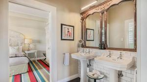 a white bathroom with two sinks and a bed at Art Deco Masonic Hotel in Napier +68 photos