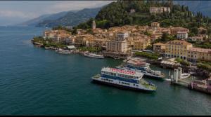 a large boat in the water next to a city at Lora Center apartment, near the lake with air conditioner in Como