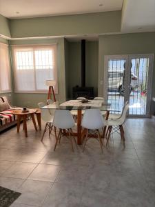 a living room with a dining room table and chairs at Hermosa casa al pie del cerro in Salta +13 photos