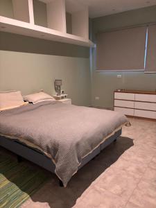 a bedroom with a large bed and a projection screen at Hermosa casa al pie del cerro in Salta