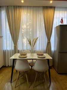 a dining room table with chairs and a table and chairsktop at #1 Location Cozy Tbilisi Gateway in Tbilisi City