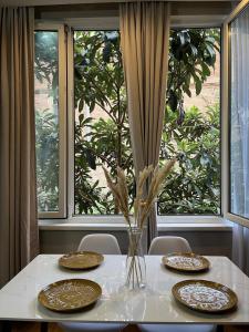 a table with four plates on it with a window at #1 Location Cozy Tbilisi Gateway in Tbilisi City