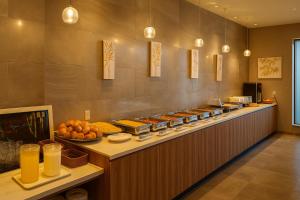 a buffet line in a restaurant with a lot of food at Plaza In Kanku Hotel in Izumi-Sano