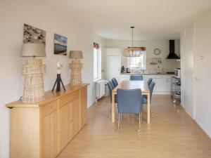 a kitchen and dining room with a table and chairs at La Courege in Zonnemaire