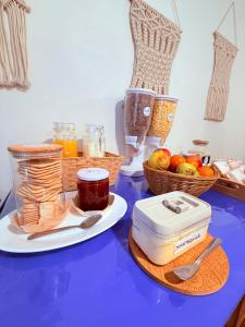a blue table with baskets of fruit and a food processor at MAKTVB BRASIL GuestHouse Hostel Boutique in Santiago