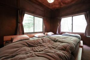 Postel nebo postele na pokoji v ubytování アウトドアアドベンチャー北軽井沢