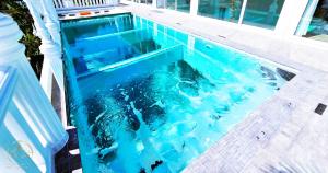 a swimming pool with blue water in a house at STARLAND Luxury Pool Villa Pattaya Walking Street 8 Bedrooms in Pattaya South