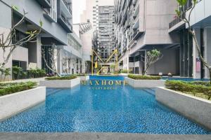 a swimming pool in the middle of a building at Maxhome Plus at Imperio Melaka in Malacca +2 photos