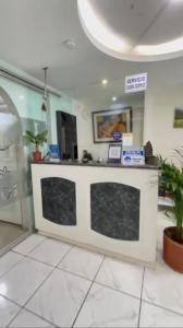 a lobby with a counter in a building at Hostal Brilliant in Quito