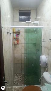 a bathroom with a glass shower with a toilet at Casa SUPER COP in Ananindeua