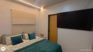a bedroom with a bed with a flat screen tv at Casa SUPER COP in Ananindeua