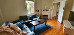 a living room with a couch and a table at Central Crisp in Albury