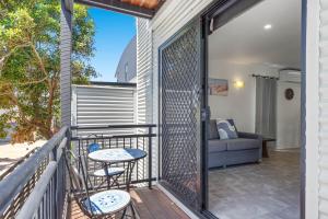 a balcony with two chairs and a couch at Bay Shore Villa in Lennox Head +8 photos