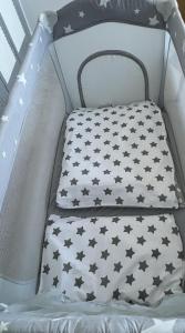 a crib with black stars on it at The Premier Living Experience Entire 2-Bedroom Modern Apartment in Bromley