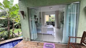 un balcone con vista su una camera da letto attraverso una finestra di Villas Pratagy- Jambu 2-Bangalô Master a Maceió