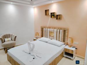 une chambre avec un lit et une chaise dans une pièce dans l'établissement Apartement de Luxe sur la plage de Achakar complexe avec piscine N2, à Tanger 46 autres photos