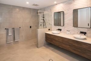 a bathroom with two sinks and a shower at Marine Life - Coastal Retreat Near Busselton Jetty in Busselton +22 photos