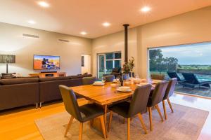 a dining room with a wooden table and chairs at Oasis - Tranquil Getaway with Pool and Scenic Outlooks in Quindalup