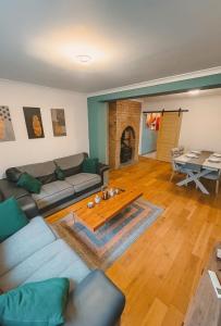 a living room with a couch and a table at Entire luxury house Free Parking accommodations for contractors and long stays in Birmingham