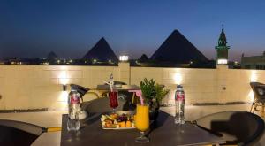 a table with a tray of food and drinks on a balcony at The kings of pyramids view inn in Cairo