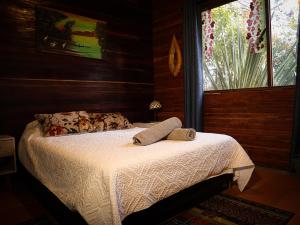 a bedroom with a bed in a room with a window at Refugio Santa Elena in Santa Elena