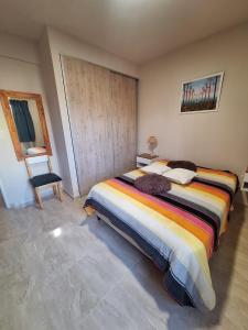 a bedroom with a bed and a chair in it at Colon Parque y Playa 2 a 4 personas in Colón