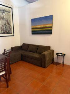 a living room with a couch and a painting on the wall at Departamento Yotao in Oaxaca City