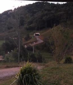 a house on the side of a hill with a road at Cabana com Piscina in Annitapolis