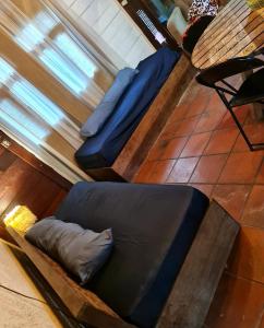 a couch sitting on the floor in a room at Casa Limoeiro 5min da ilha in Alter do Chao +19 photos