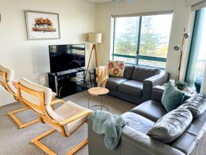 a living room with a couch and a couch at Campbells Cove Unit 1, 30 Esplanade Headland, King in Caloundra