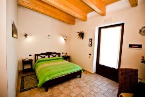 A bed or beds in a room at Masseria La Gravina