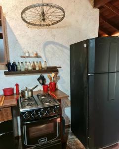 a kitchen with a stove and a refrigerator at Casa Limoeiro 5min da ilha in Alter do Chao