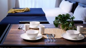 a table with plates and utensils on top of a room at Minn Kamata in Tokyo