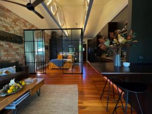 a living room with a couch and a table at Moa Studios - Stay Waiheke in Blackpool