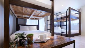 a bedroom with two bunk beds and a table at Minn Kamata in Tokyo