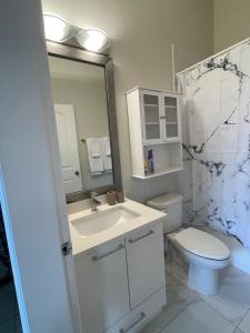 a bathroom with a sink and a toilet and a mirror at 3 Bed - Best View in Town! in Surrey +13 photos
