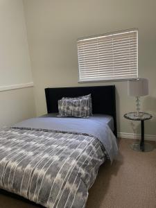 a bedroom with a bed with a pillow and a table at 3 Bed - Best View in Town! in Surrey