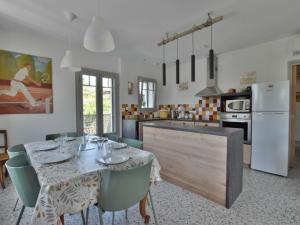 a kitchen and dining room with a table and chairs at Maison rénovée, confort moderne, quartier calme, parking - FR-1-498-120 in Thonon-les-Bains