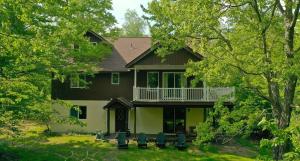 a large house with chairs in front of it at Luxury Mountain Villa - 3 bedroom, hot-tub, fire-pit in Hunter