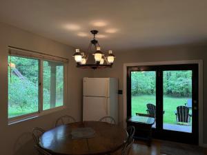 a dining room with a table and a refrigerator at Luxury Mountain Villa - 3 bedroom, hot-tub, fire-pit in Hunter +16 photos