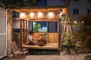 a man sitting on a table in a pavilion at Lu's Homestay in Dong Hoi +32 photos